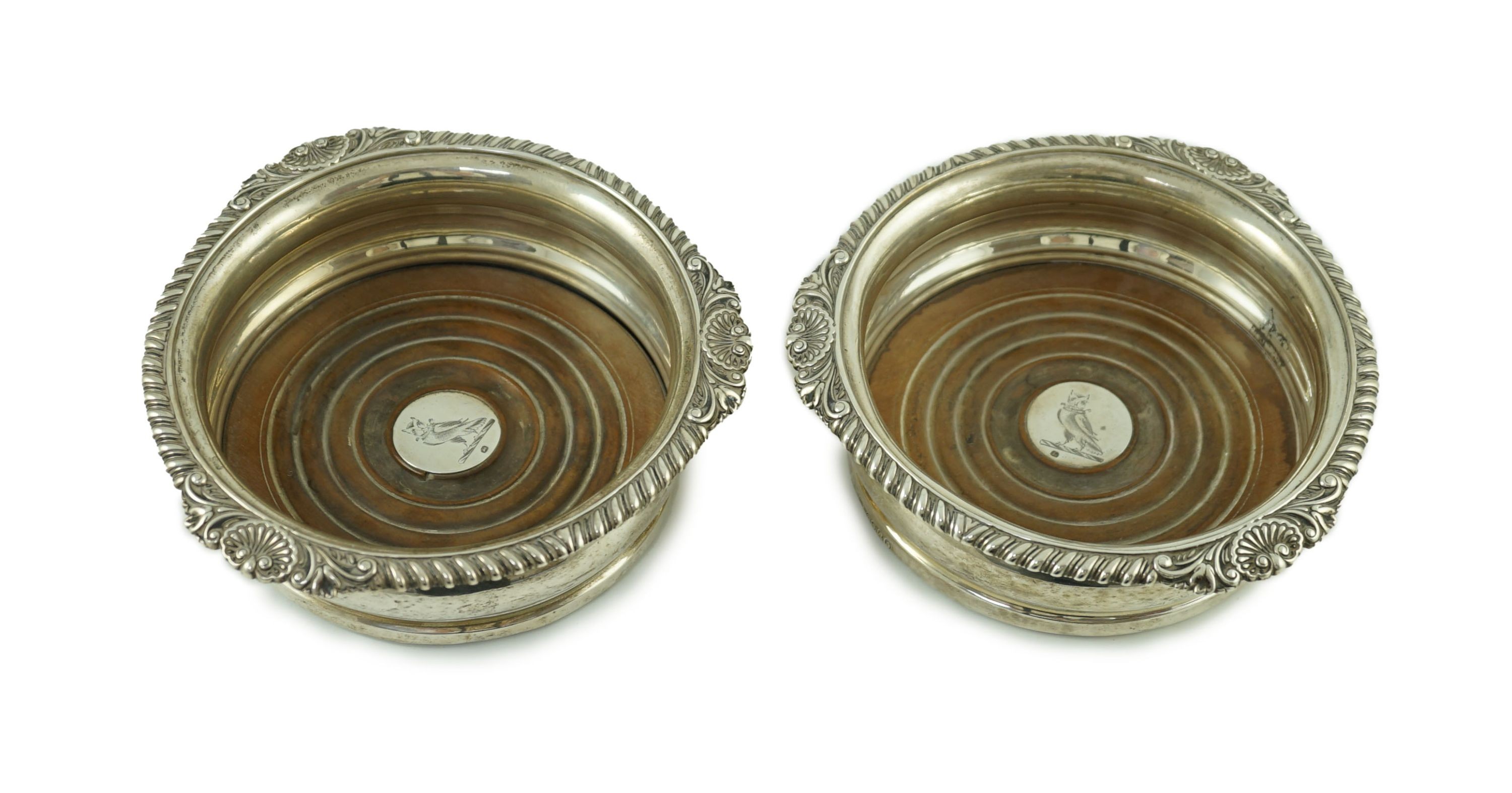 A pair of George IV silver wine coasters by Benjamin Smith III